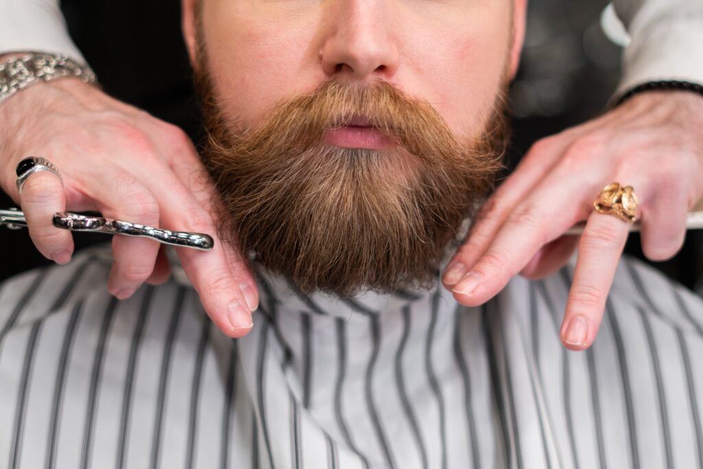 Beard is cut by barber